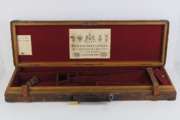A late 19th century 12 gauge leather shotgun case having carry handle and twin straps, marked HP,