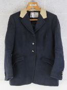 A Bernard Weatherill navy ladies hunting jacket with plastic Pychley HUnt buttons upon,
