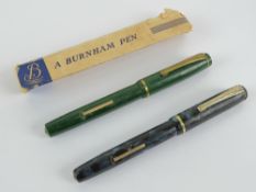 A vintage 'self-filling' fountain pen by Burnham having 14ct gold nib and sleeve,