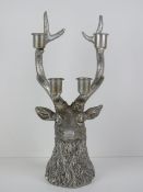 A table decoration in the form of a stags head complete with five point antlers having four candle