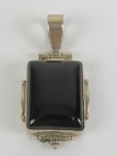 A 925 silver and square shaped onyx pendant having hinged bale over, 4.2cm in length.