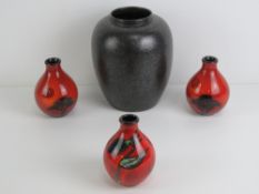 A Mid 20th century Poole Pottery black lustre vase standing 22cm high.