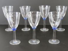 A set of seven hand blown wine glasses having mottled blue bead to stem,
