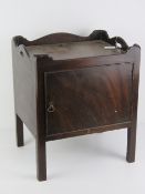 A Georgian mahogany pot cupboard, single door opening to reveal compartment within,