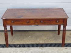 A Georgian mahogany low frieze table having twin drawers and raised over turned octagonal legs,