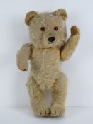 Looking for a new home - A vintage mohair fully jointed Teddy bear having internal musical chime,