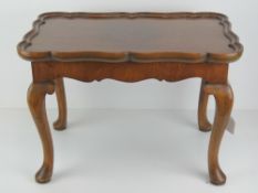 A fine quarter veneered walnut tray table having detachable pie crust tray measuring 53 x 35cm,