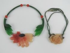 Two c1940s lucite necklaces, one of a partially opened rosebud with leaves behind, 5.