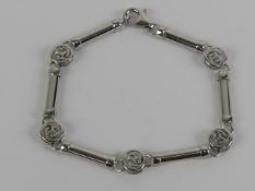 A 9ct white gold bracelet having alternating bar and Celtic pattern panels, 19.