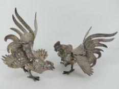 A pair of fighting cocks silver plated table centrepiece decorations, each approx 18cm in length.