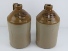 A pair of salt glazed stoneware one gallon jugs having printed marks upon for Duckworth & Co Ltd
