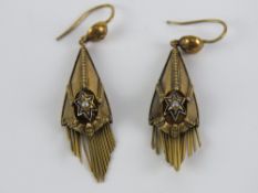 A pair of Victorian yellow metal earrings having seed pearl at centre of enamelled star with fringe