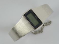 A Seiko stainless steel digital watch with instruction booklet.