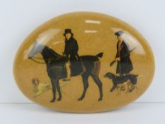 A transfer printed paperweight stone or doorstop featuring huntsman with hunting dogs, 12cm dia.
