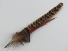 A vintage feathered hat pin or brooch 23cm in length.