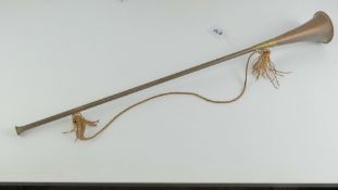 A copper and brass coaching horn, with carry strap, 65cm in length.