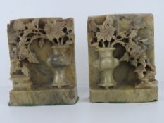 A pair of Oriental carved and pierced soapstone bookends, each standing 15cm high, slightly a/f.