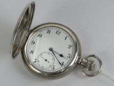A hallmarked silver full hunter top wind pocket watch having white enamel dial with black Arabic