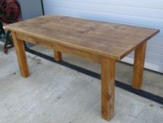 A contemporary solid pine kitchen table raised over substantial square cut legs, 6ft x 3ft.