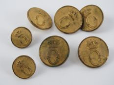 A set of brass Oakley Hunt buttons (five large + two small).