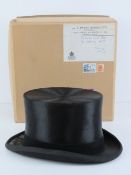A silk top hat by S Patey London, size 7 1/4, with makers cardboard box with label upon.