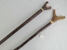 A walking stick with deer antler handle, together with a split top walking stick with antler collar,