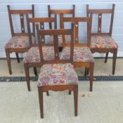 A set of six oak framed dining chairs of Arts and Crafts influence each with matching