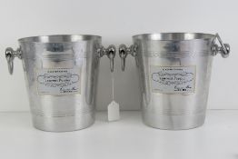 A pair of Laurent Perrier metal champagne ice buckets each standing 20cm high.