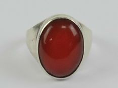 A HM silver carnelian signet ring having large central oval cabachon 17 x 12mm, worn hallmark,