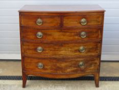 A late Georgian bow fronted chest of two short over three long drawers,