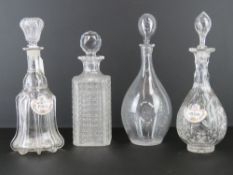 Four assorted cut glass decanters together with two ceramic labels for Port and Sherry.