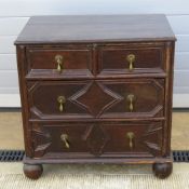 A Carolean revival chest of two short over two long drawers all with brass teardrop handles,