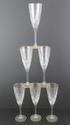 A set of six champagne flutes having gilded rims and each standing 22cm high.