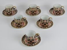 Royal Crown Derby; Six Imari pattern coffee cans and saucers,