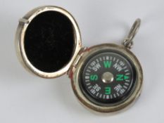 A HM silver pendant opening to reveal compass within, hallmarked to jump ring, 27mm dia.