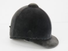 A velvet covered peak riding hat as made by Lock & Co London, size 6 3/4.