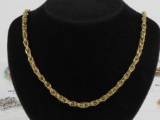 A 9ct gold chain necklace having polished double links surrounding a row of planished links,