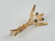 A yellow metal floral brooch, no apparent hallmark - one possibly Continental stamp near pin,