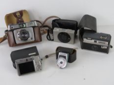 Camera equipment; a Yashica Yem35 Super lightmeter, a Kodak Instamatic 50, two Canon cameras,