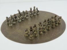An unusual Oriental chess set having engraved brass board and metal pieces. Board 28.