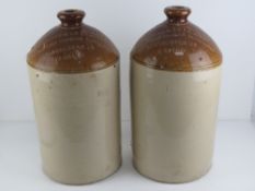 A pair of salt glazed stoneware four gallon jugs having impressed marks for Duckworth & Co Ltd