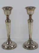 A pair of HM silver single candlesticks, each standing 22cm high and hallmarked for Birmingham 1965.