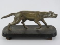 A well cast brass hunting dog mounted on cast iron base, 22cm in length.