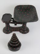 A good hand painted set of grocers balance scales, with eight graduated weights 1/2oz to 4lbs.