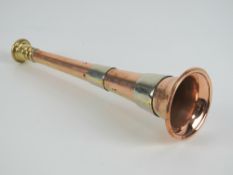 A copper and brass banded hunting horn, 23cm in length, with leather case.