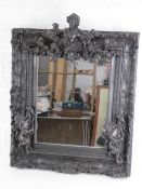 A highly decorative bronzed composite square shaped wall mirror having floral and foliate swags