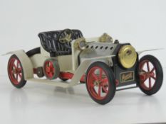 A Mamod live steam car, single piston, burner deficient, complete with drive spring, 40cm in length.