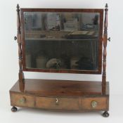 An early 19thC mahogany bow fronted toilet mirror,