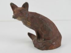A fine cold painted bronze seated fox figurine by Michael Storey, signed to back of tail,