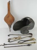A copper coal scuttle with swing handle, together with a set of bellows, fire irons, tongs etc.